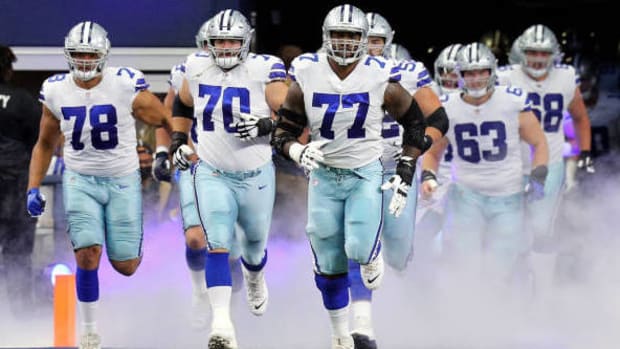 ARLINGTON, TEXAS - OCTOBER 03: Terence Steele #78, Zack Martin #70, and Tyron Smith #77 of the Dallas Cowboys lead the team on to the field before the game against the Carolina Panthers at AT&T Stadium on October 03, 2021 in Arlington, Texas. (Photo by Richard Rodriguez/Getty Images)